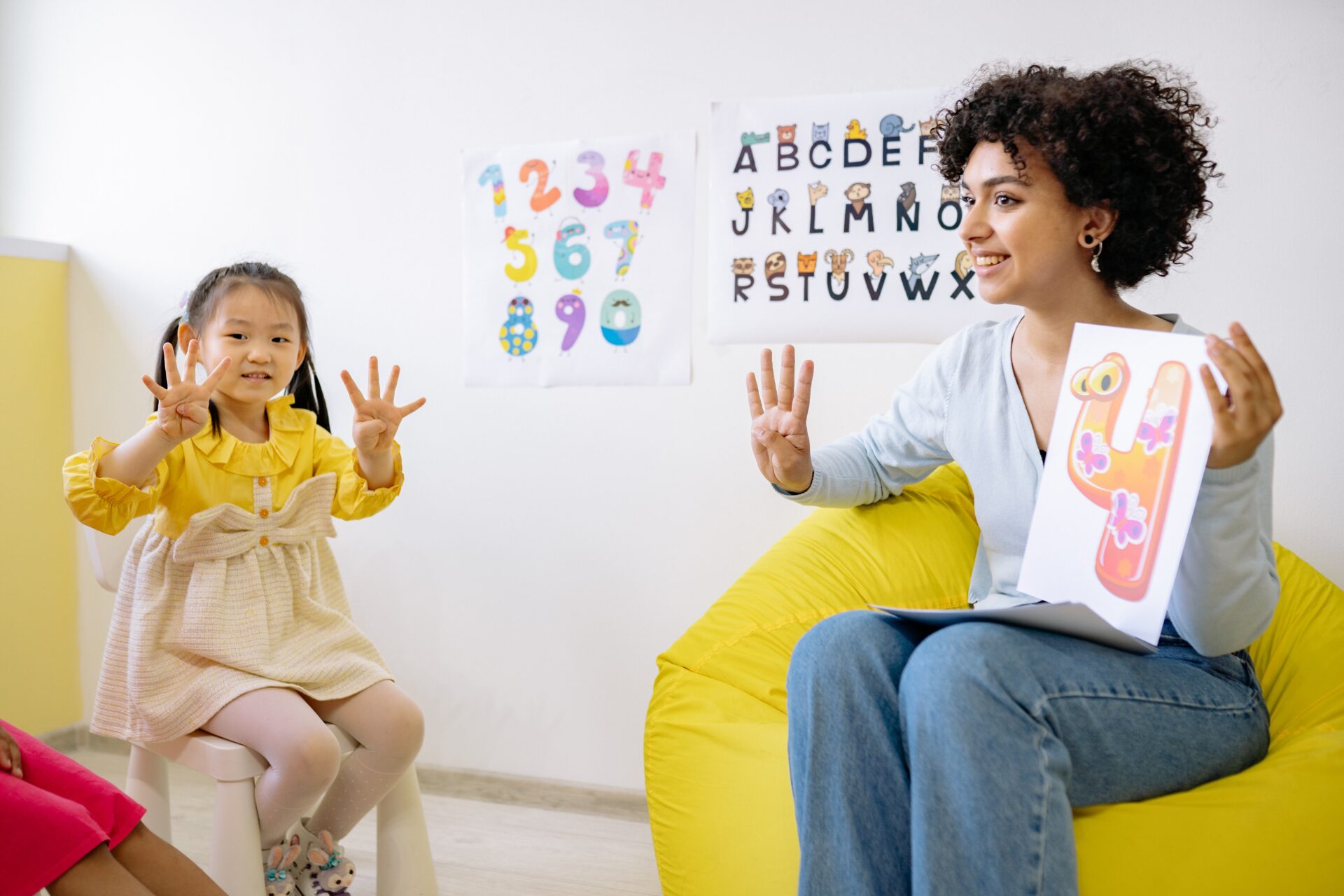 A woman and child sitting in front of each other.