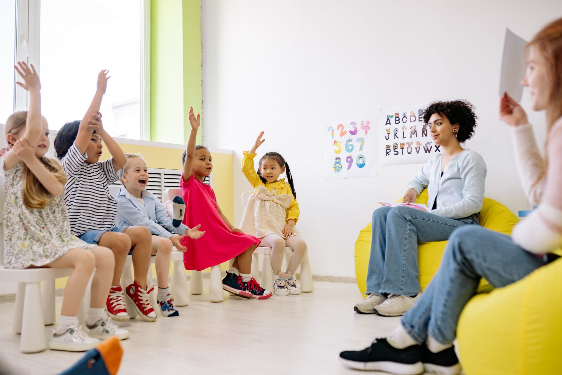 A group of children sitting in front of an adult.